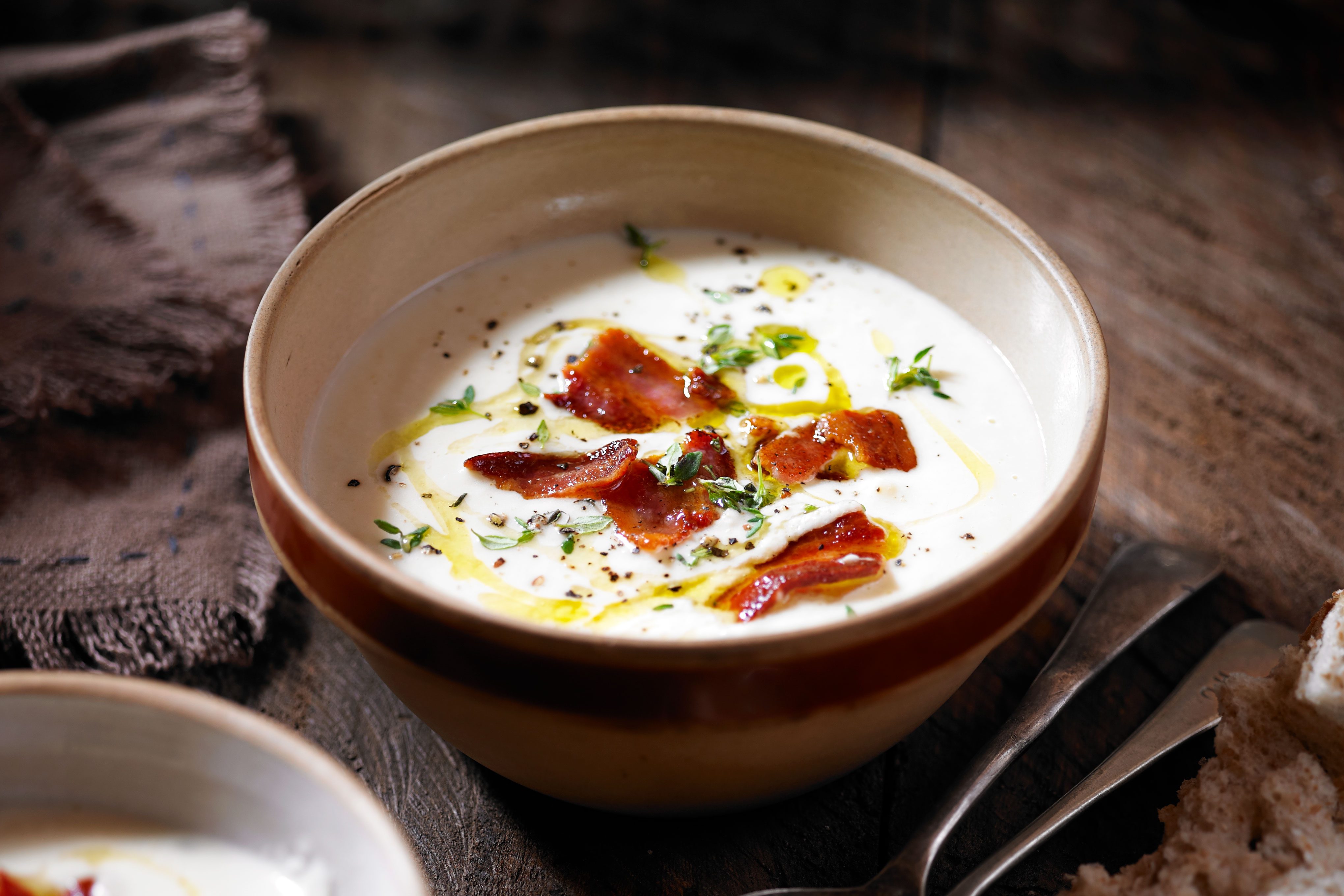 Celeriac, pancetta & thyme soup Bowl of celeriac soup topped with pancetta and thyme