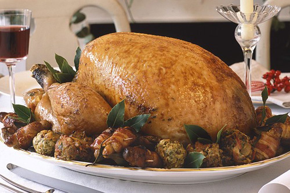 Classic roast turkey Roast turkey on a platter with stuffing balls