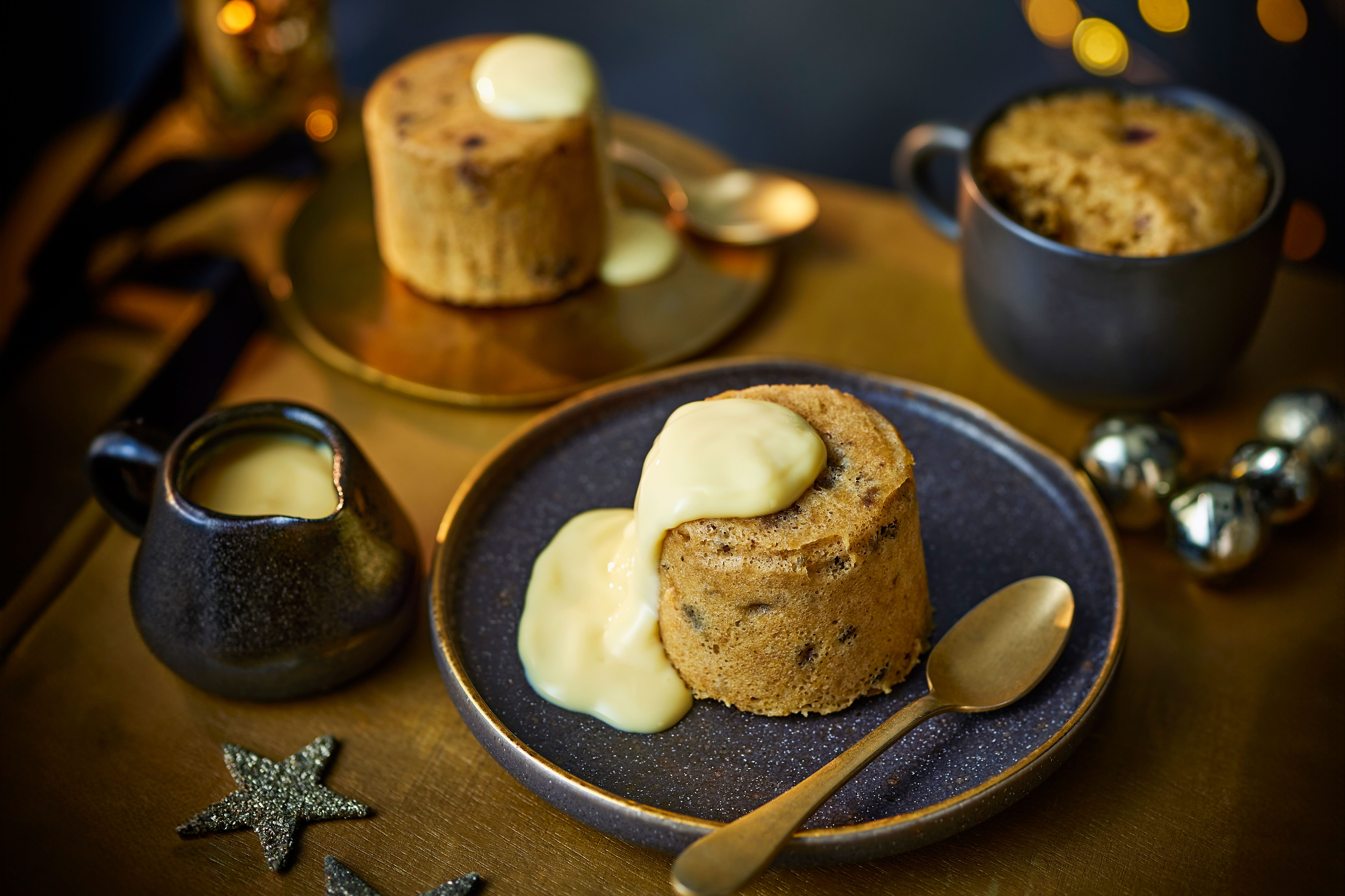 Microwave Christmas mug cake on a plate with custard