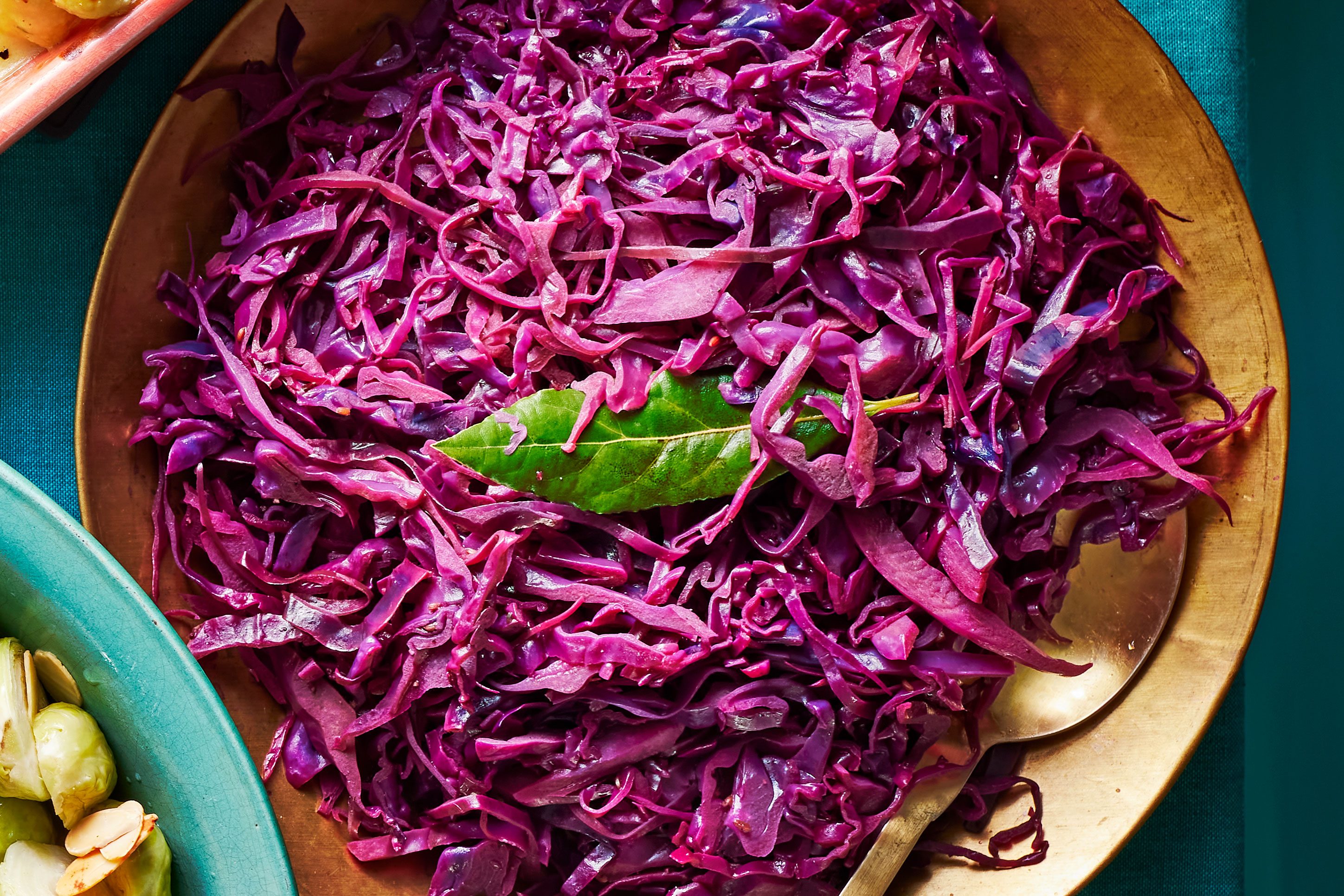 Bowl of red cabbage topped with a leaf