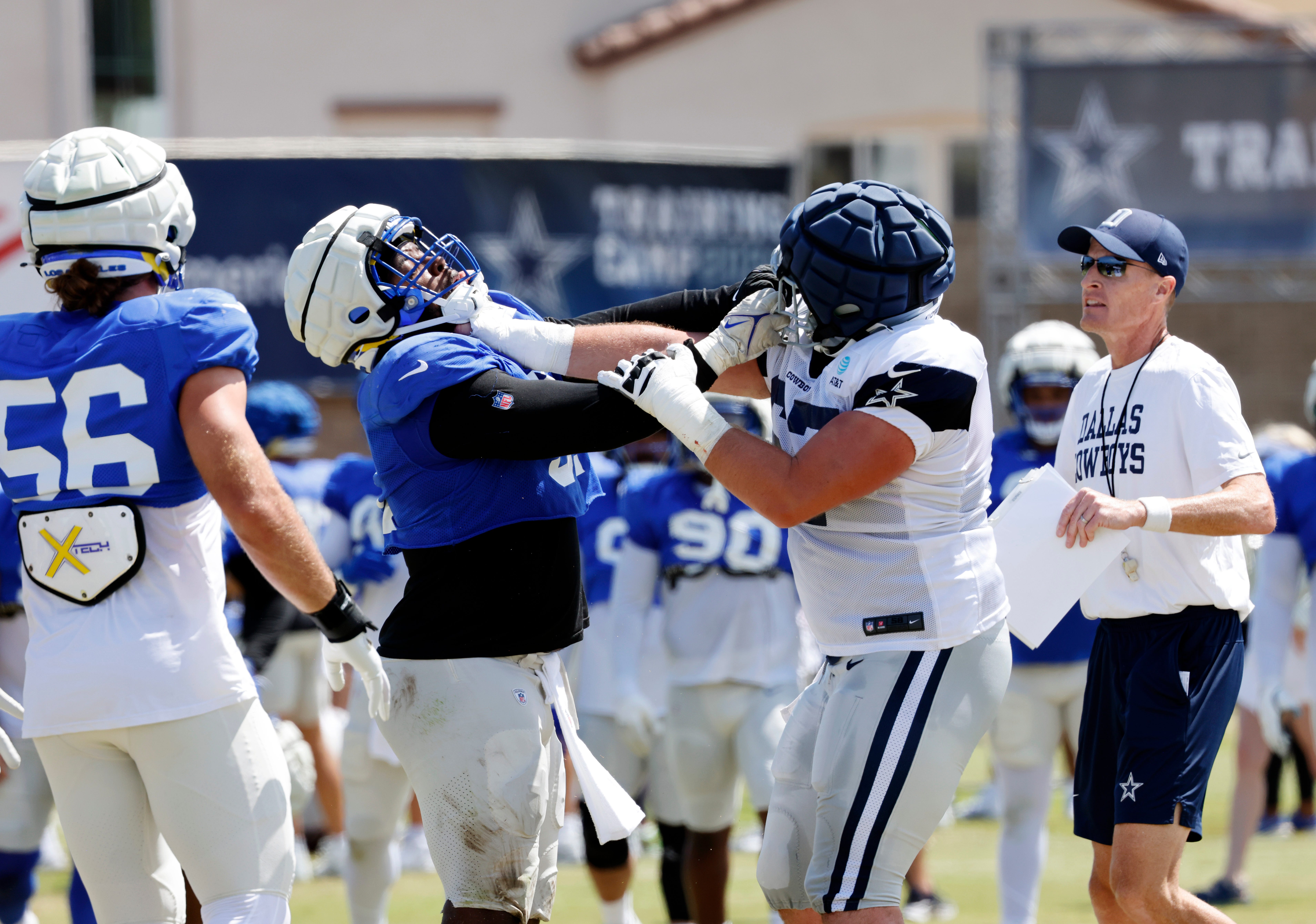 OXNARD, CALIFORNIA - AUGUST 8: Defensive tackle Kobie Turner #91 of the Los Angeles Rams locks up with center Brock Hoffman #67 of the Dallas Cowboys during a skirmish between the two teams during joint practice at training camp on August 8, 2024 in Oxnard, California. (Photo by Kevork Djansezian/Getty Images)