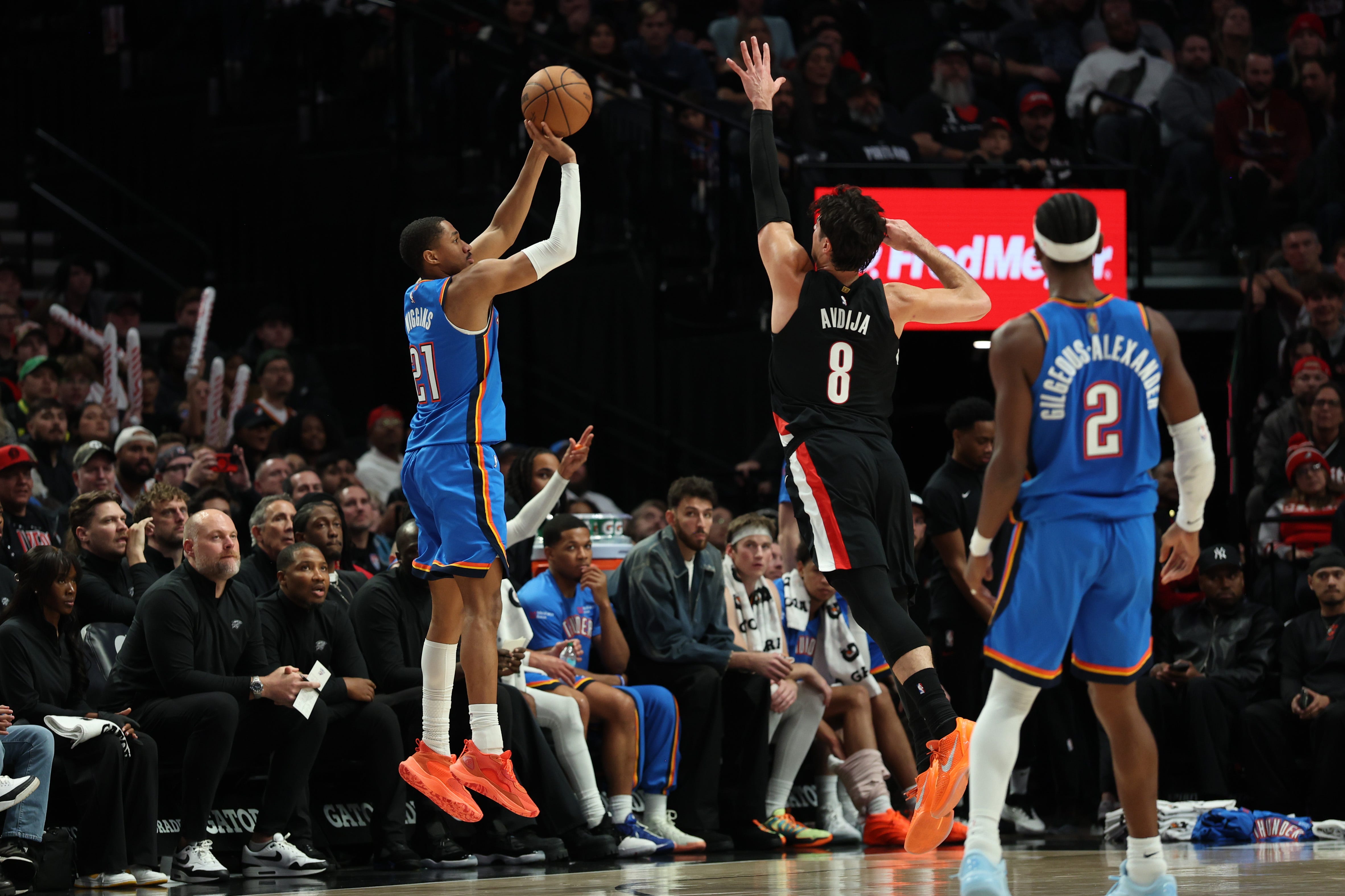 Nov 5, 2025; Portland, Oregon, USA; Oklahoma City Thunder guard Aaron Wiggins (21) shoots the ball over Portland Trail Blazers forward Deni Avdija (8) during the second half at Moda Center. Mandatory Credit: Jaime Valdez-Imagn Images