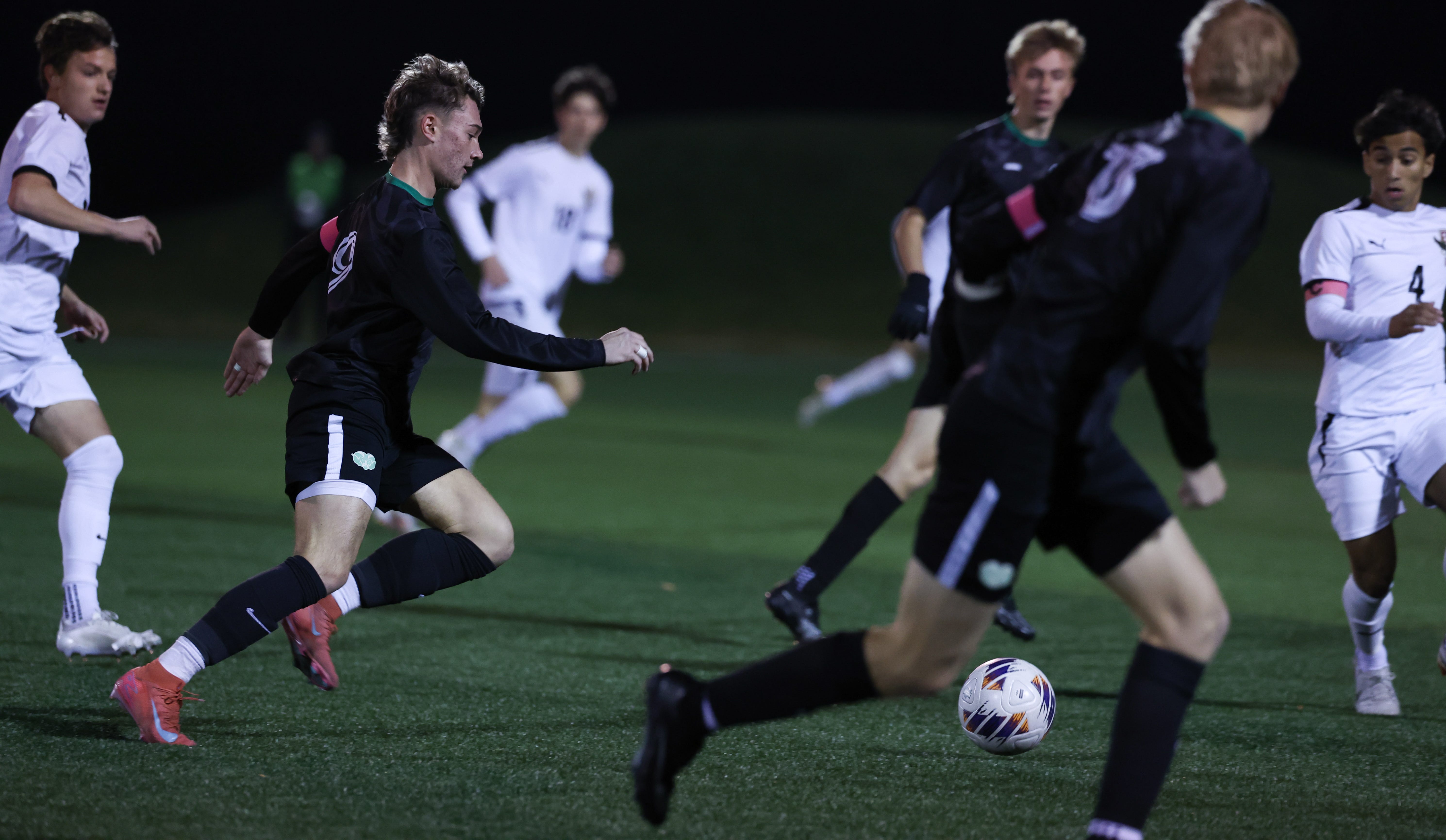 Luke Hickey (left) of Hamilton Badin dribbles the ball into the offensive side of the pitch in the first half of the OHSAA DIII state semifinal boys soccer game Wednesday, Nov. 5, 2025. Bishop Watterson won the game 1-0, with 10:39 left in overtime.