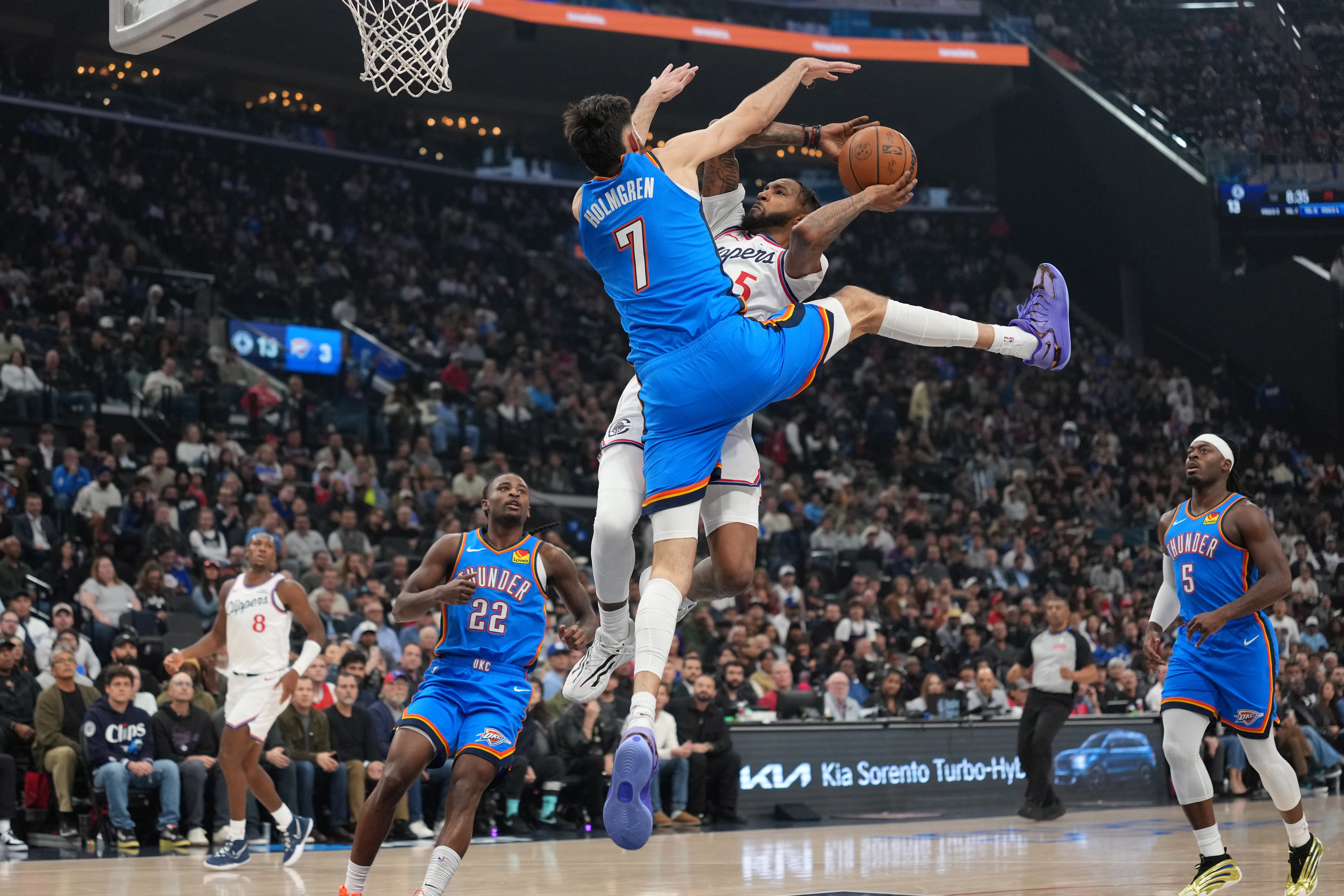 Nov 4, 2025; Inglewood, California, USA; LA Clippers forward Derrick Jones Jr. (5) shoots the ball against Oklahoma City Thunder center Chet Holmgren (7) in the first half at Intuit Dome. Mandatory Credit: Kirby Lee-Imagn Images