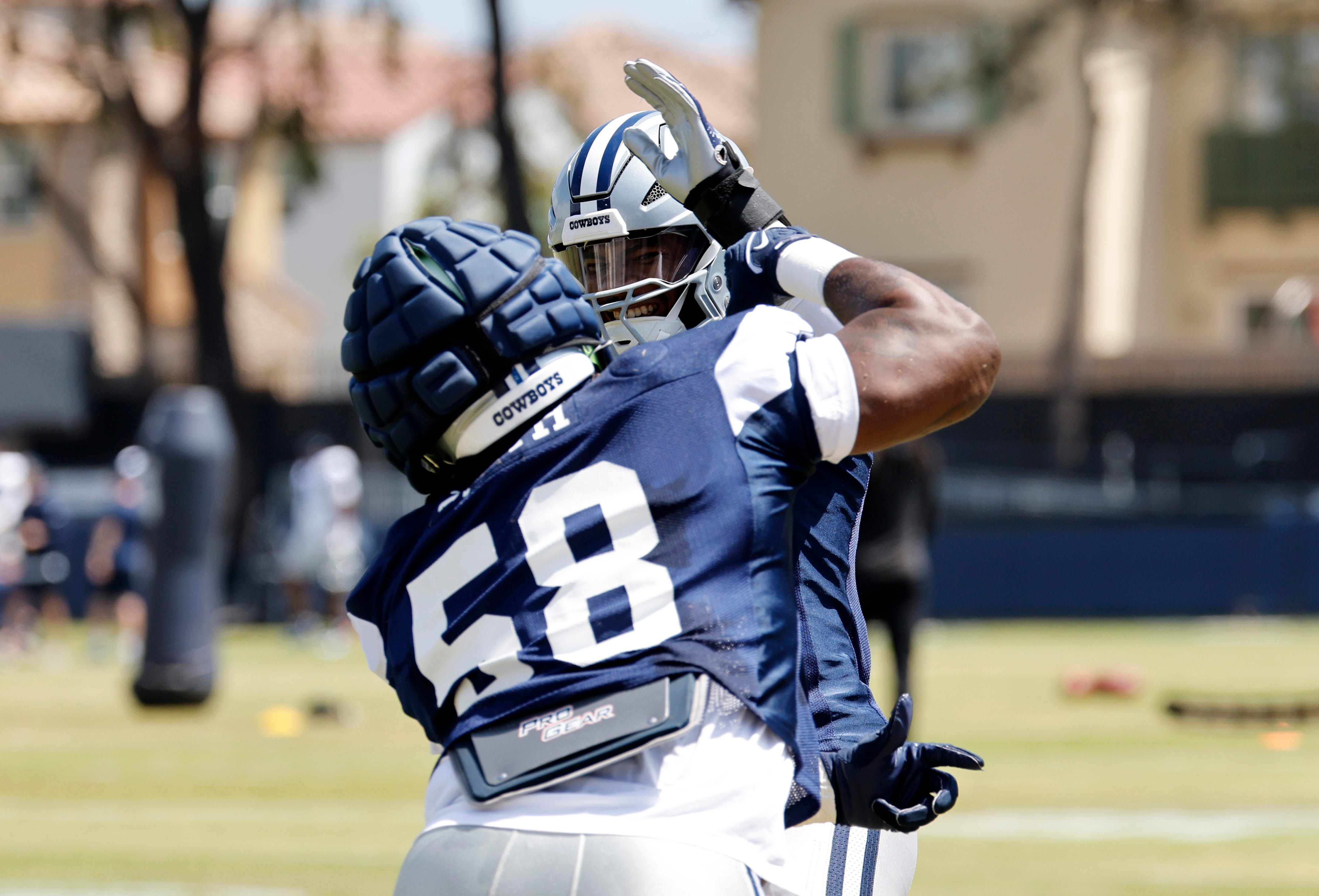 OXNARD, CALIFORNIA - JULY 30: Linebacker Micah Parsons #11 and defensive tackle Mazi Smith #58 of the Dallas Cowboys throw punches aa they jokingly spar prior to a training session on July 30, 2024 in Oxnard, California. (Photo by Kevork Djansezian/Getty Images)