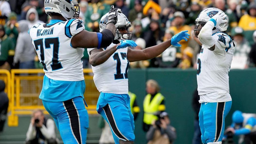 Rico Dowdle celebrates scoring a touchdown for the Carolina Panthers against the Green Bay Packers in November 2025