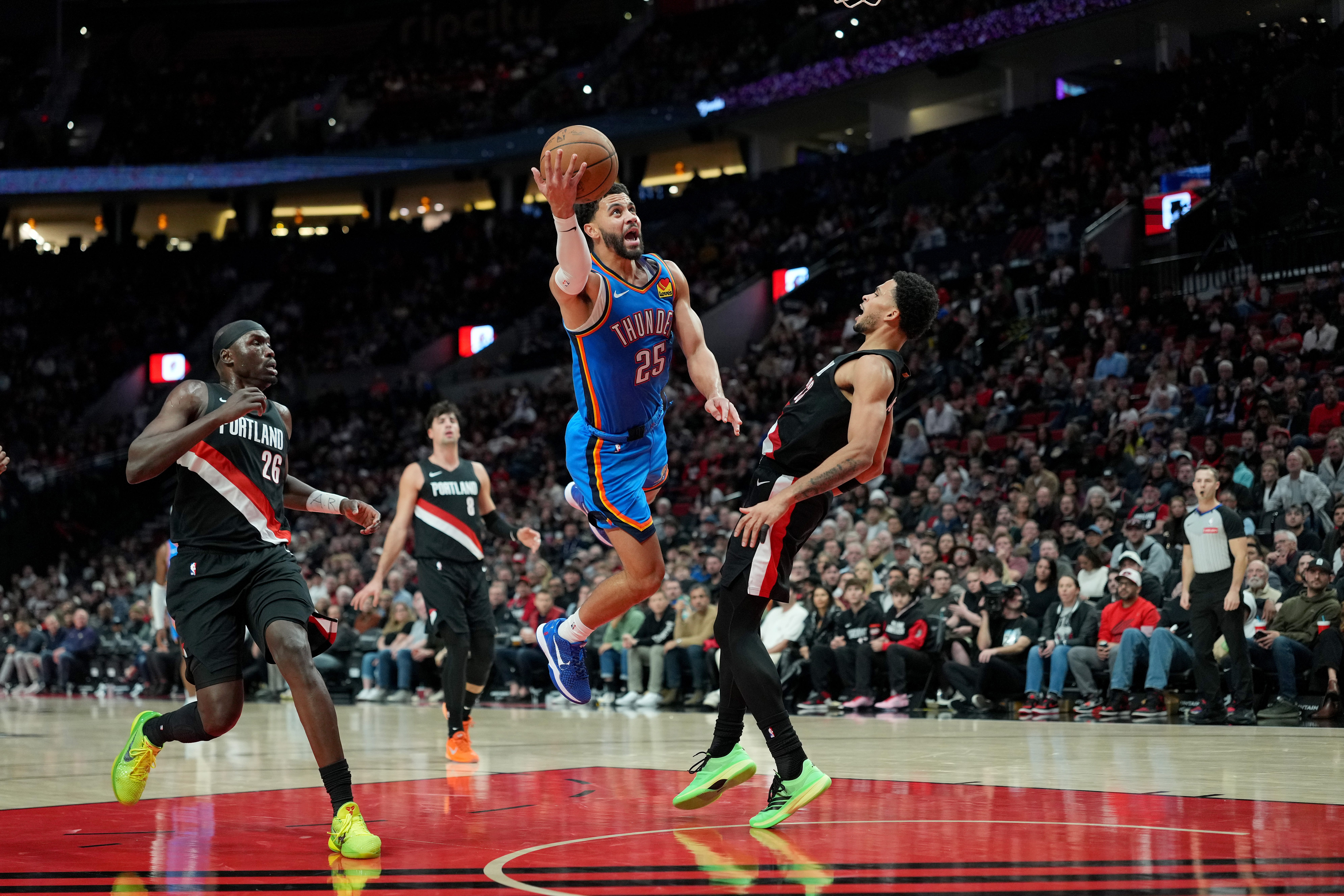 PORTLAND, OREGON - NOVEMBER 05: Toumani Camara #33 of the Portland Trail Blazers draws a charge from Ajay Mitchell #25 of the Oklahoma City Thunder during the first half at Moda Center on November 05, 2025 in Portland, Oregon. NOTE TO USER: User expressly acknowledges and agrees that, by downloading and or using this photograph, User is consenting to the terms and conditions of the Getty Images License Agreement. (Photo by Soobum Im/Getty Images)