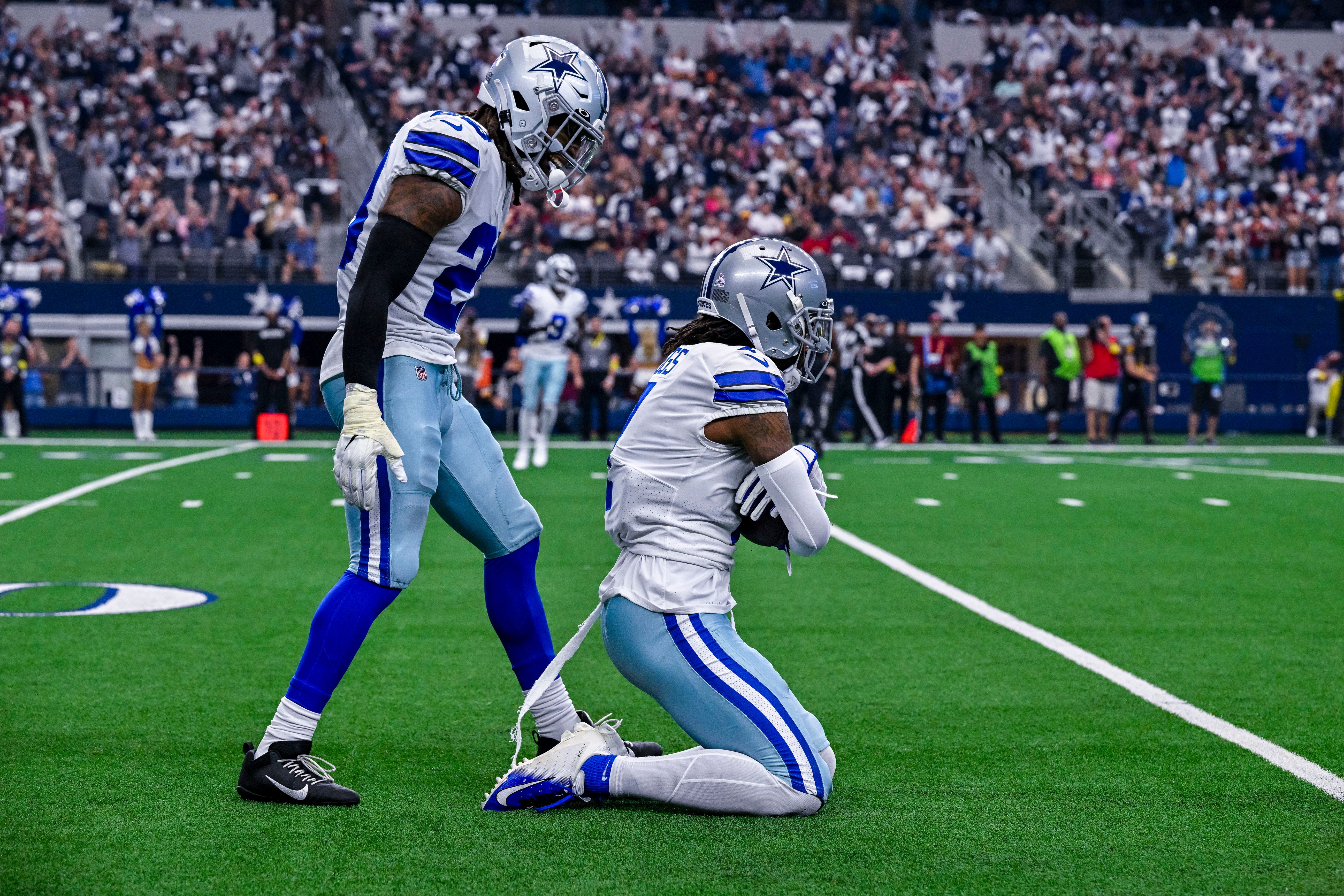 Oct 2, 2022; Arlington, Texas, USA; Dallas Cowboys cornerback DaRon Bland (26) and cornerback Trevon Diggs (7) celebrate after Diggs intercepts a pass against the Washington Commanders during the game at AT&T Stadium. Mandatory Credit: Jerome Miron-USA TODAY Sports