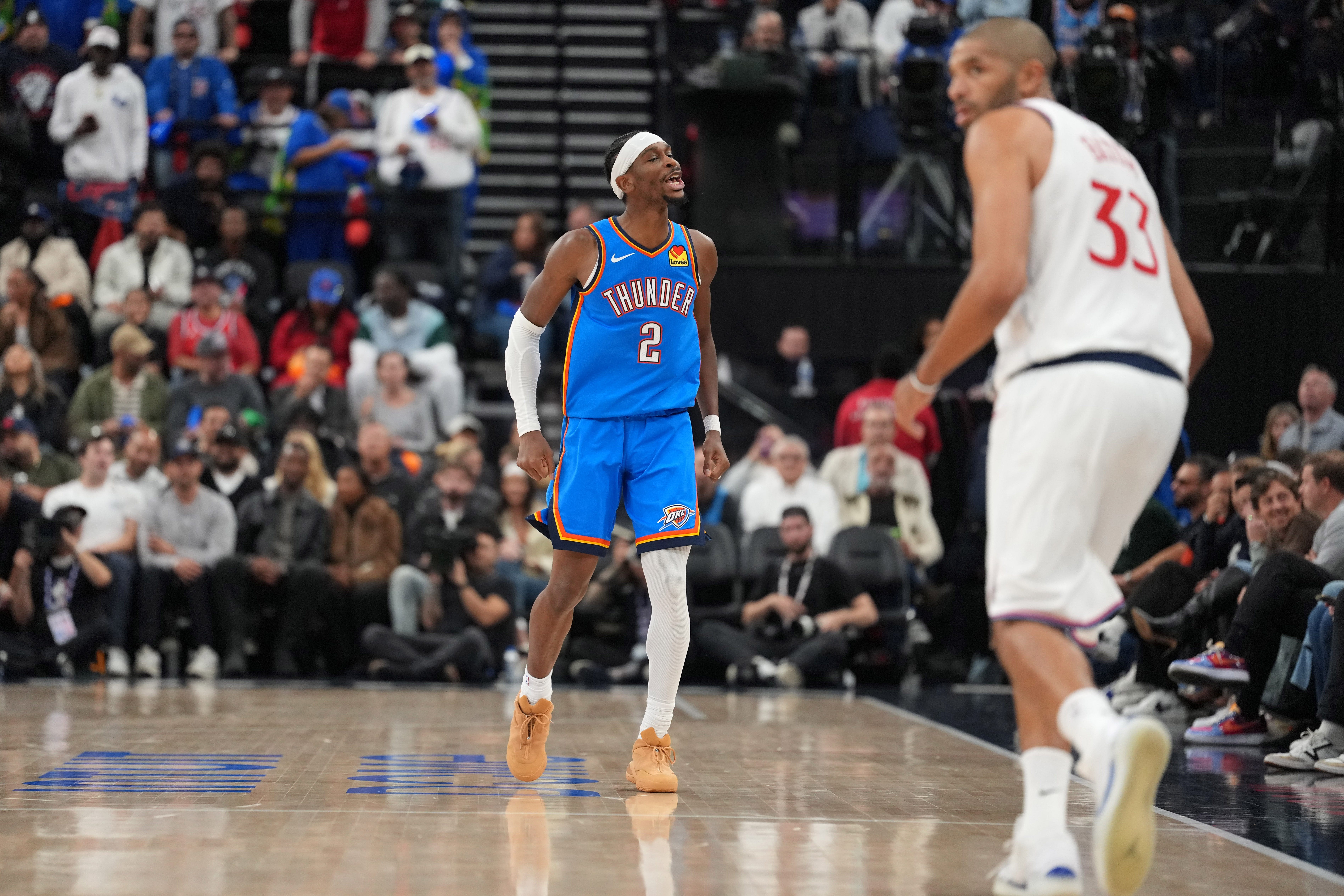 Nov 4, 2025; Inglewood, California, USA; Oklahoma City Thunder guard Shai Gilgeous-Alexander (2) celebrates in the second half as LA Clippers forward Nicolas Batum (33) watches at Intuit Dome. Mandatory Credit: Kirby Lee-Imagn Images
