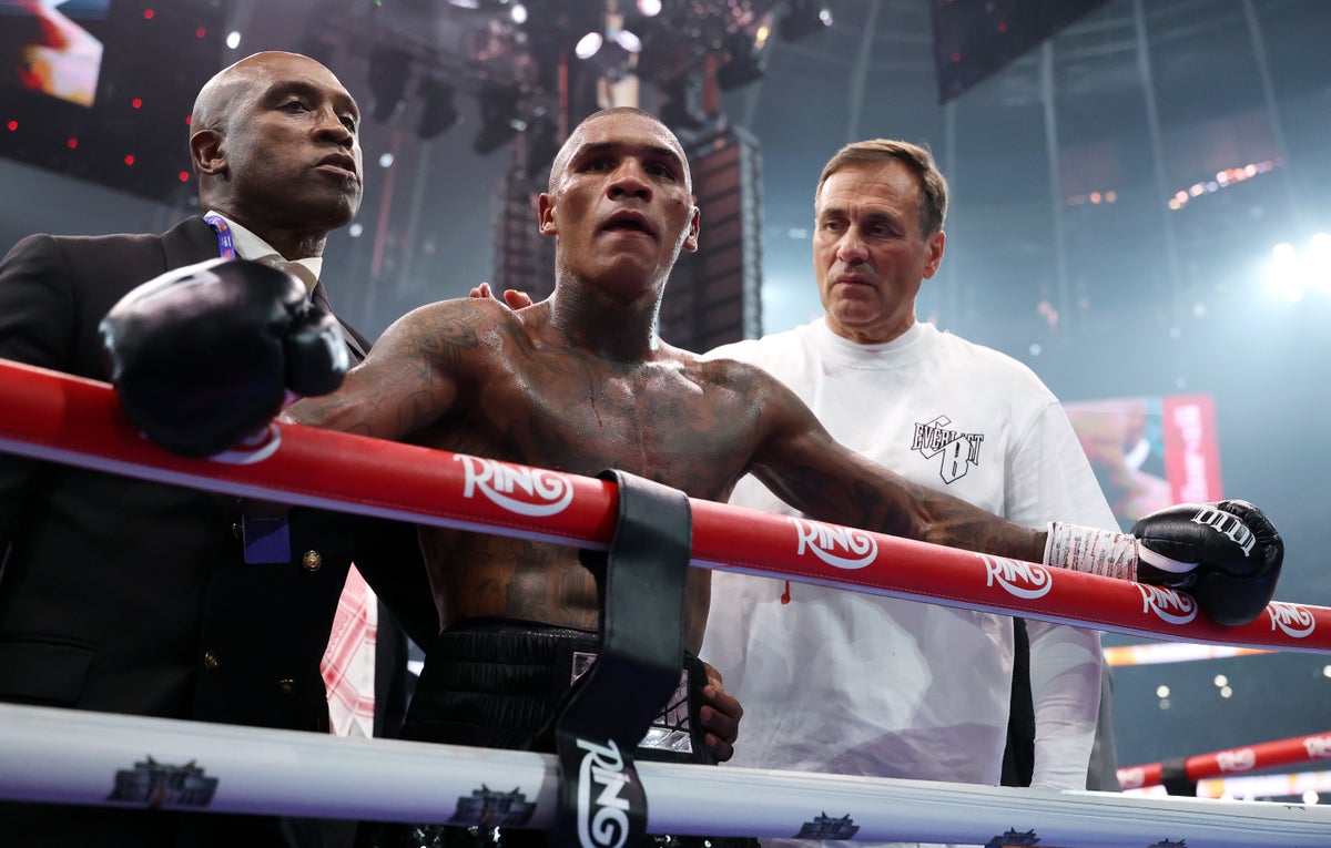 A devastated Benn with his father Nigel and coach Tony Sims after losing to Eubank Jr (Getty)