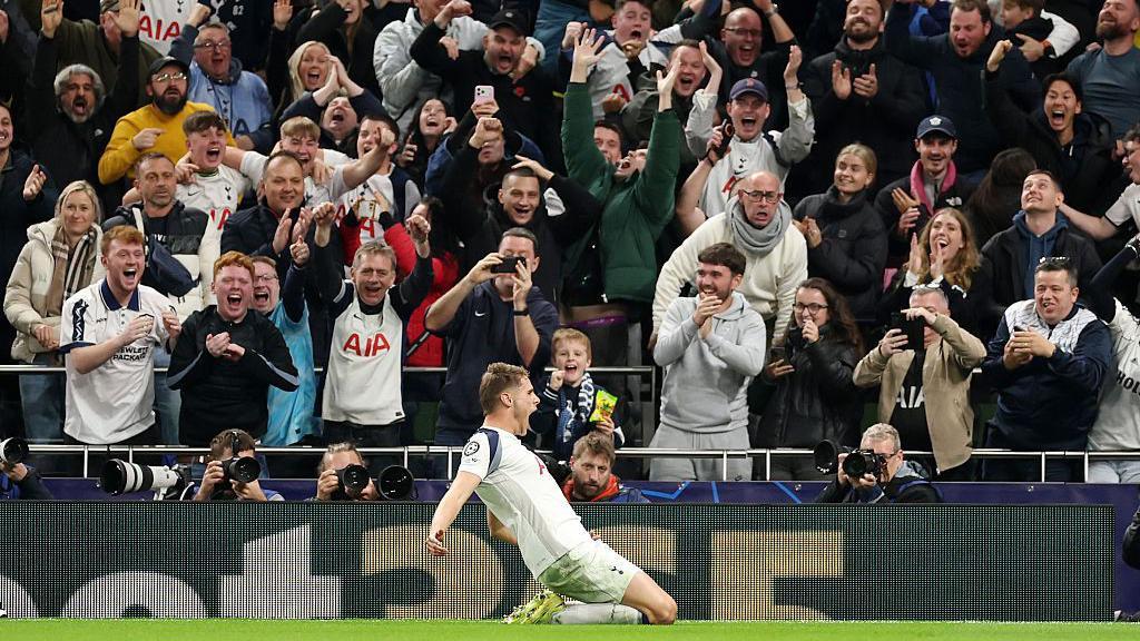 Micky van de Ven slides in front of the fans