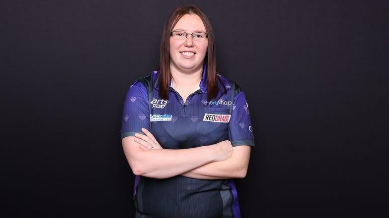 Gemma Hayter wearing purple with her arms folded staring at the camera.