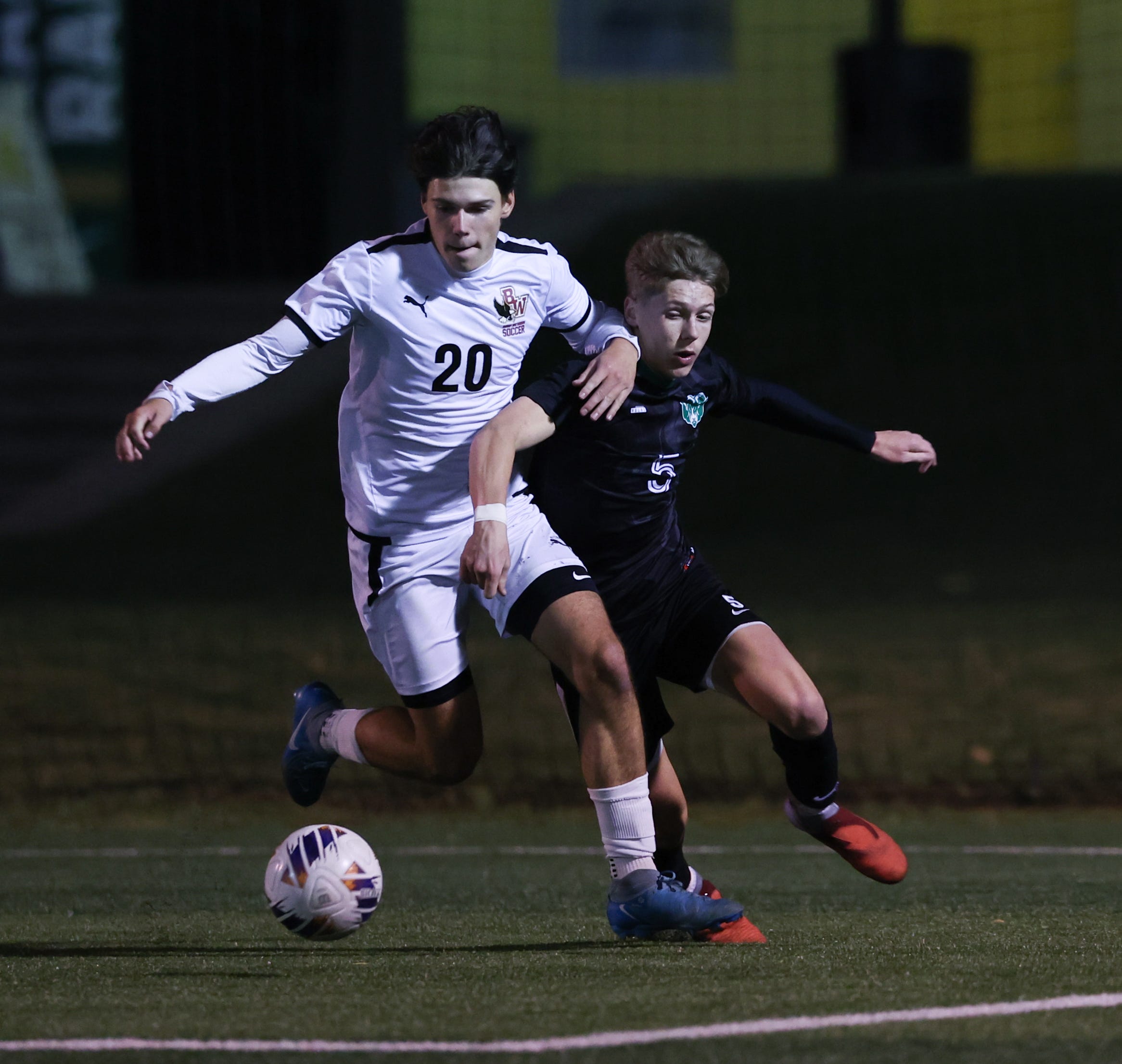 Michael Quinn (left) of Bishop Watterson and Tanner Questa of Hamilton Badin both try to gain possession in overtime of the OHSAA DIII state semifinal boys soccer game Wednesday, Nov. 5, 2025. Bishop Watterson won the game 1-0, with 10:39 left in overtime.