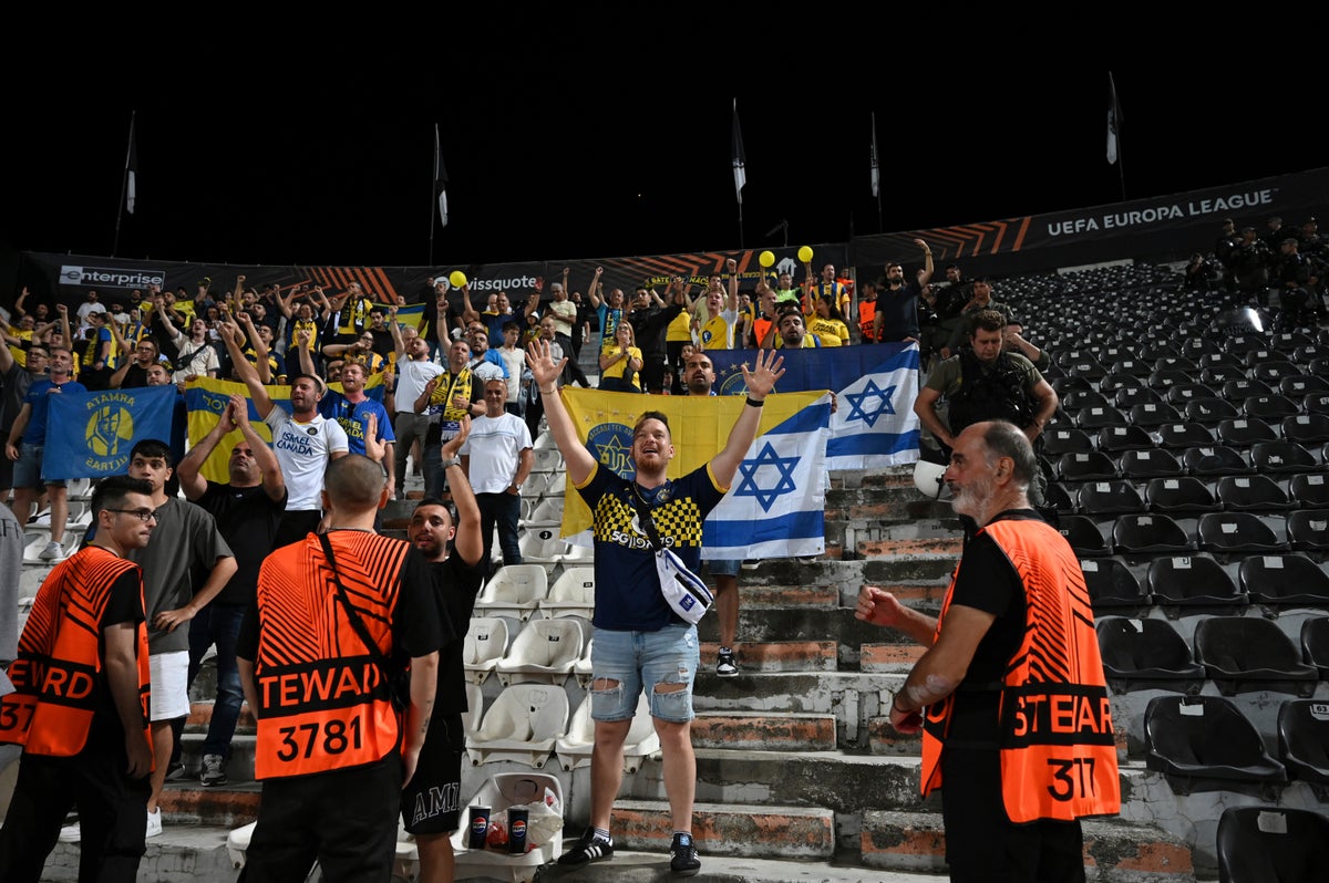 Maccabi Tel Aviv’s fans at the end of their Europa League match against PAOK in Thessaloniki, Greece in September (AP)
